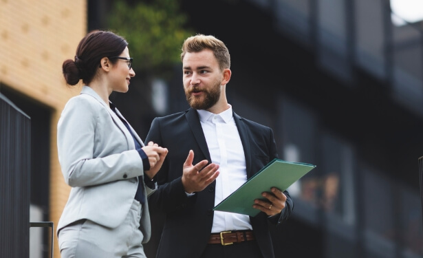 two business colleagues discussing while walking